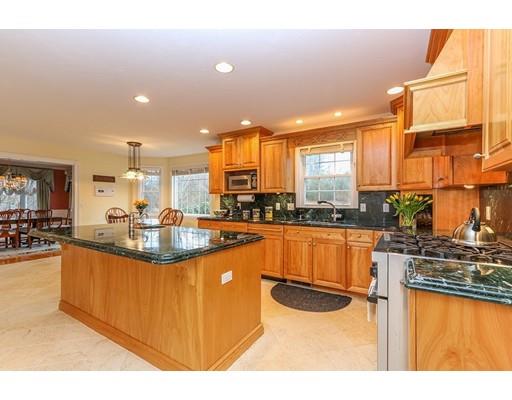 7 Rose Road Millis, MA 02054 - Photo 5 of 28 a large white kitchen with stainless steel appliances granite countertop a stove and cabinets