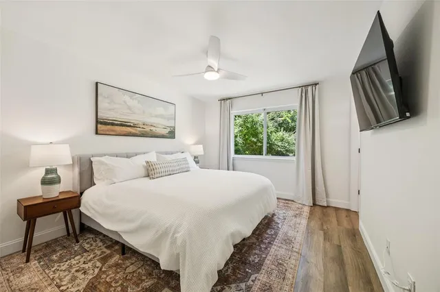 a bedroom with a large bed and a window