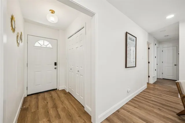 a view of a hallway with wooden floor