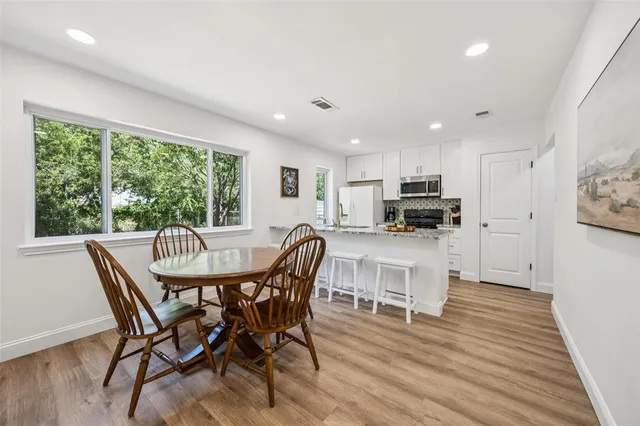 a view of a dining room with furniture and wooden floor
