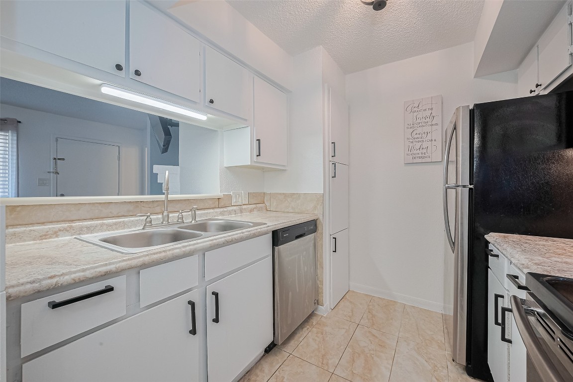 1505 Ward Road, Unit 118 Baytown, TX 77520 - Photo 11 of 35 a kitchen with a sink stove and refrigerator