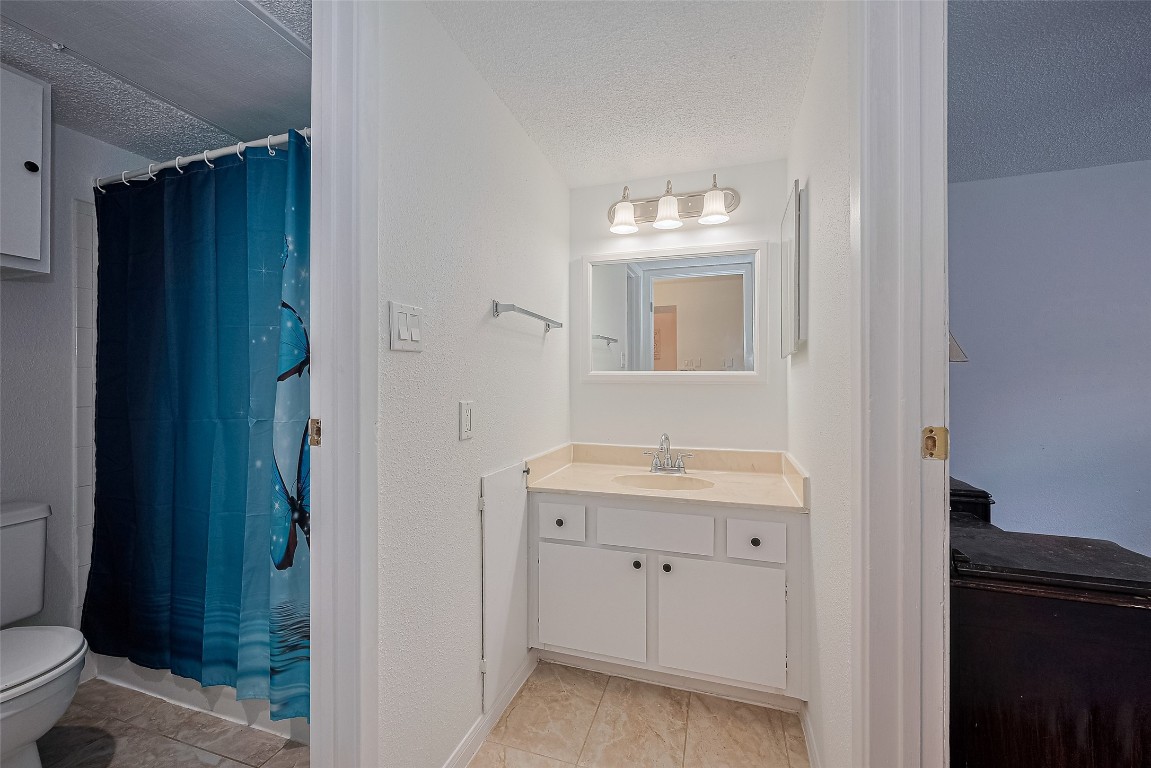 1505 Ward Road, Unit 118 Baytown, TX 77520 - Photo 23 of 35 a bathroom with a toilet sink and mirror