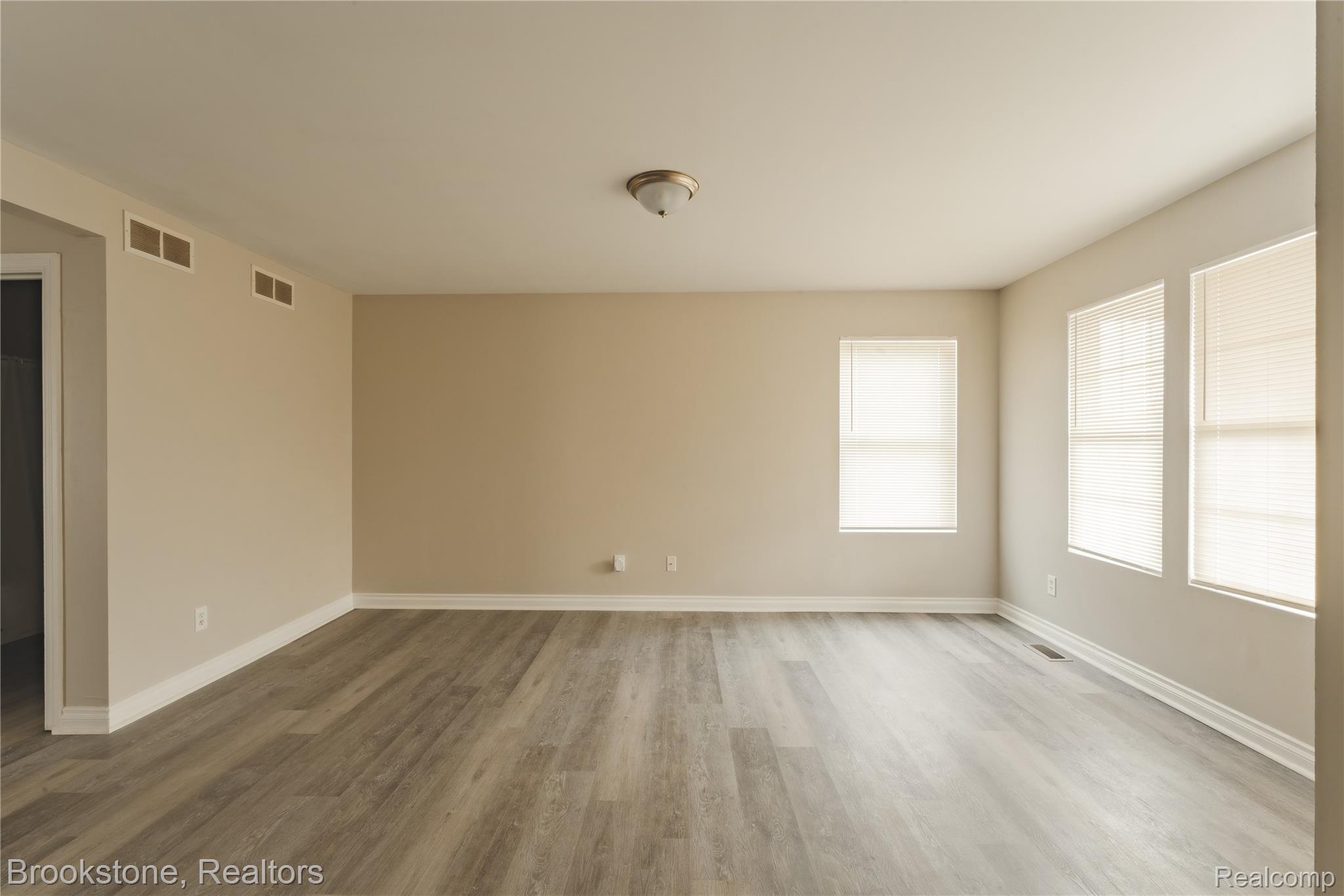 270 Franklin Road Pontiac, MI 48341 - Photo 5 of 46 Living room featuring wood-finish flooring, neutral wall tones, white baseboards, and multiple windows with blinds