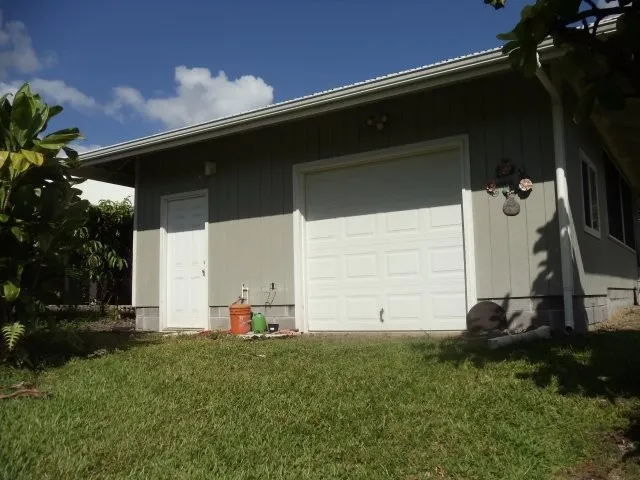 a backyard of a house with lots of green space and plants