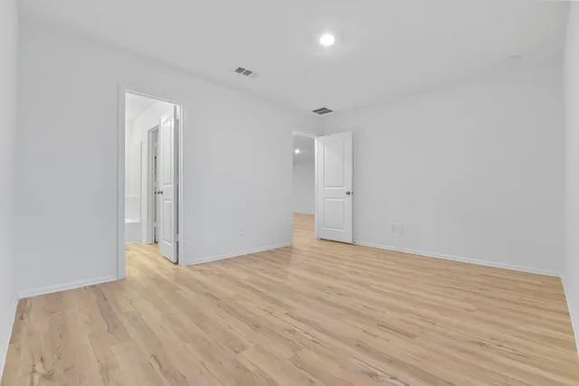 a view of an empty room and wooden floor