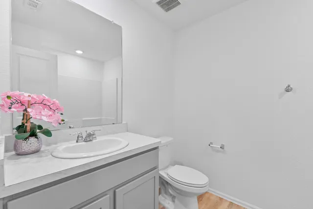a bathroom with a sink toilet and a mirror