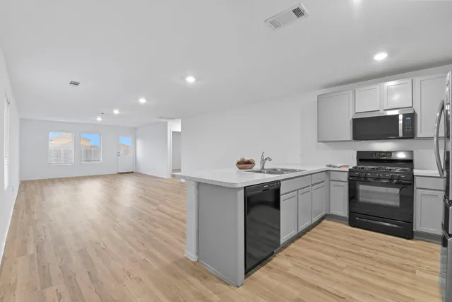 a kitchen with stainless steel appliances granite countertop a sink stove and oven