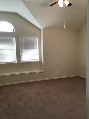 an empty room with a empty space and windows