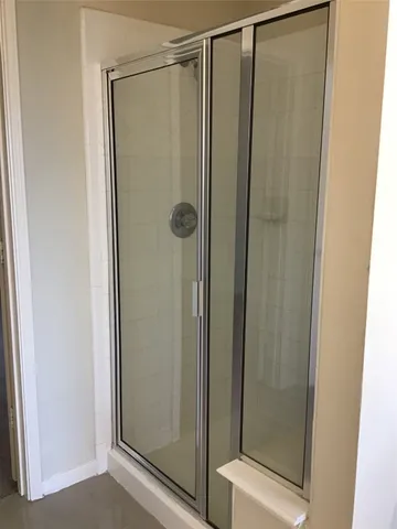 a bathroom with a glass shower door