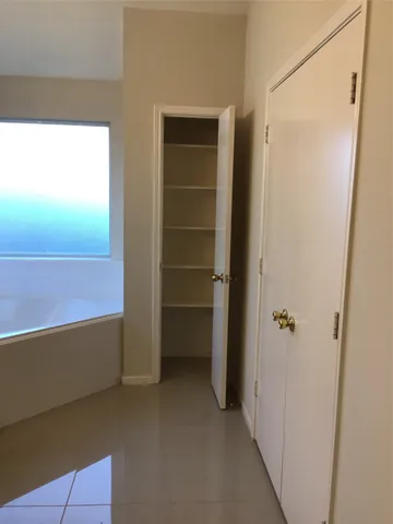 a view of backyard with small cabin and wooden fence