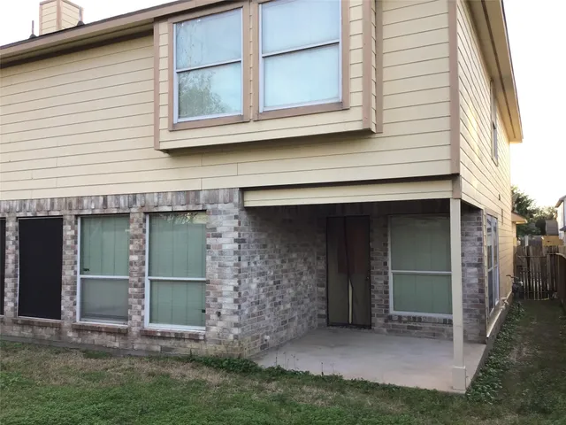 a large tree in the front of a house