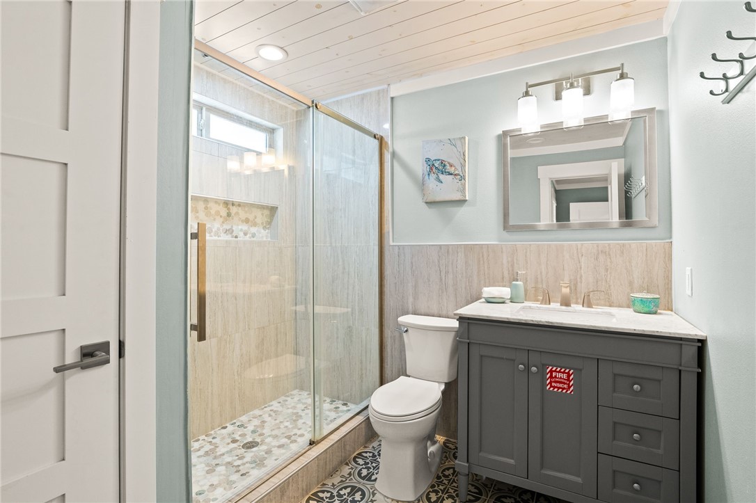 715 Beach Access Road, Unit 1005 Port Aransas, TX 78373 - Photo 20 of 28 a bathroom with a sink a toilet and shower