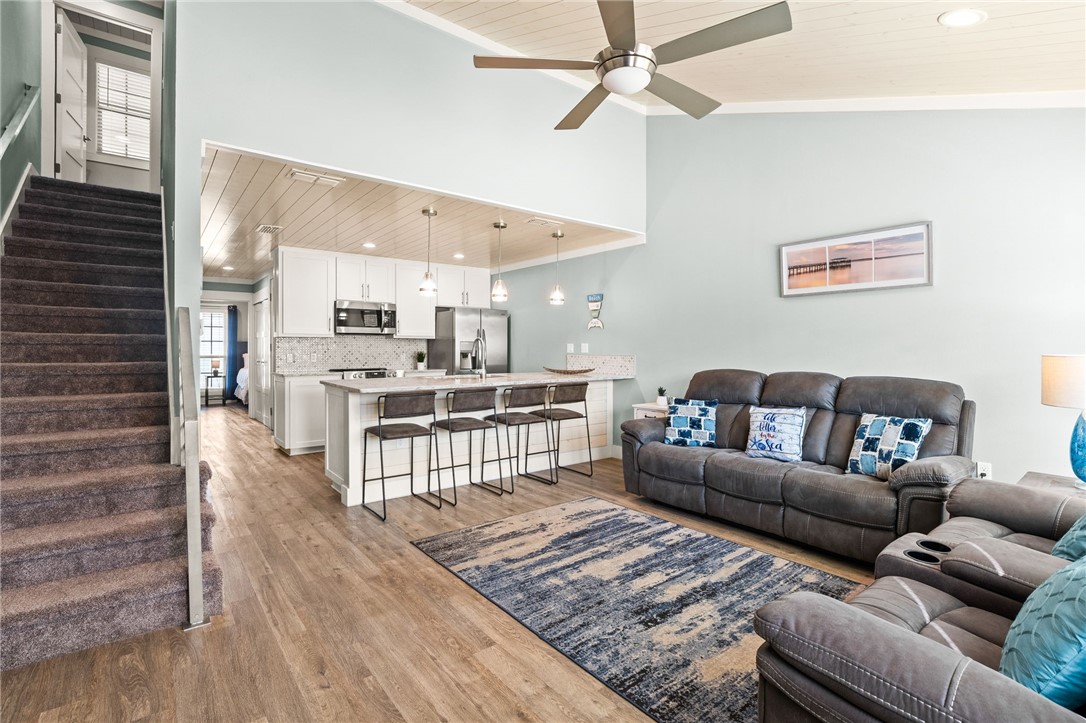 715 Beach Access Road, Unit 1005 Port Aransas, TX 78373 - Photo 2 of 28 a living room with furniture and a wooden floor