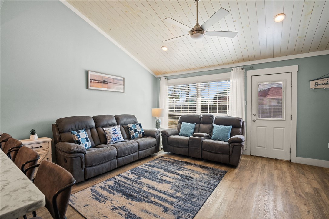 715 Beach Access Road, Unit 1005 Port Aransas, TX 78373 - Photo 4 of 28 a living room with furniture a ceiling fan and a window