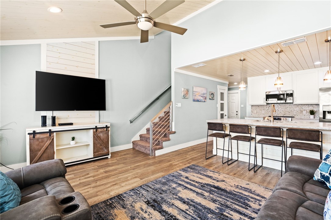 715 Beach Access Road, Unit 1005 Port Aransas, TX 78373 - Photo 5 of 28 a living room with furniture and a flat screen tv