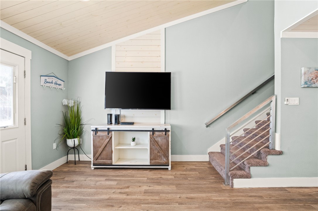 715 Beach Access Road, Unit 1005 Port Aransas, TX 78373 - Photo 6 of 28 a living room with furniture and a flat screen tv