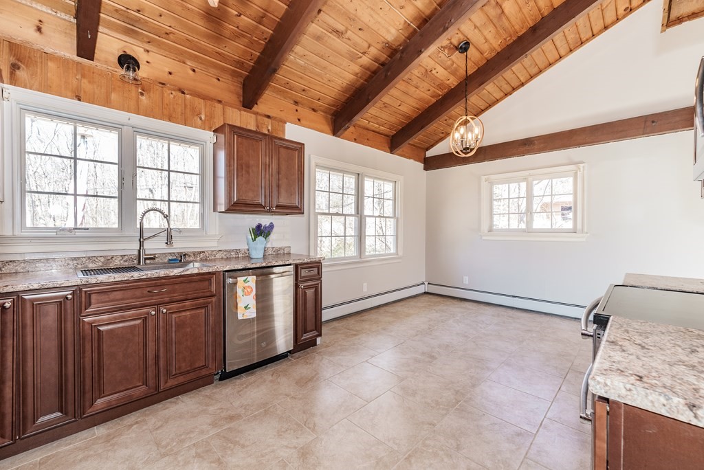 78 Pine Ridge Road Montgomery, MA 01085 - Photo 12 of 42 a large kitchen with granite countertop a sink window and cabinets