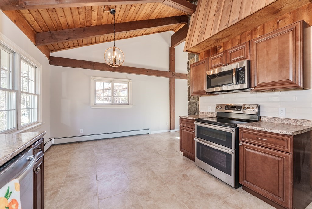 78 Pine Ridge Road Montgomery, MA 01085 - Photo 14 of 42 a kitchen with stainless steel appliances granite countertop a stove and a microwave