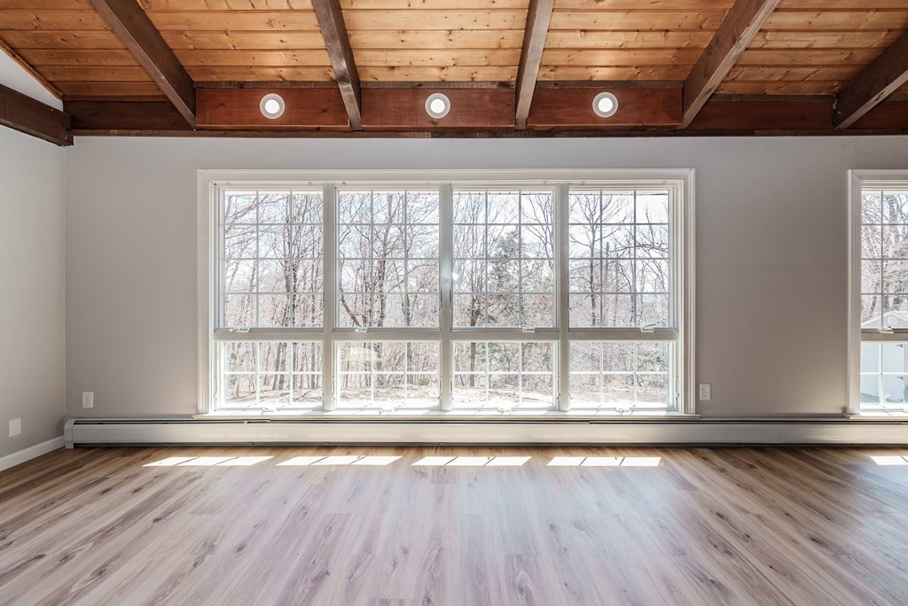 78 Pine Ridge Road Montgomery, MA 01085 - Photo 15 of 42 a view of an empty room with wooden floor and a window
