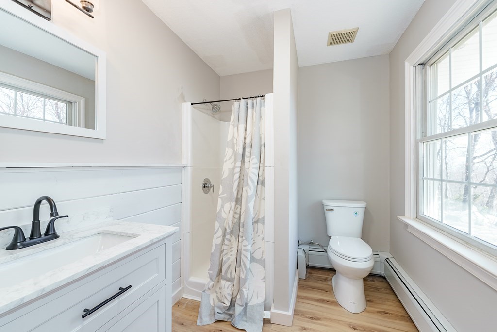 78 Pine Ridge Road Montgomery, MA 01085 - Photo 22 of 42 a bathroom with a toilet sink and a window