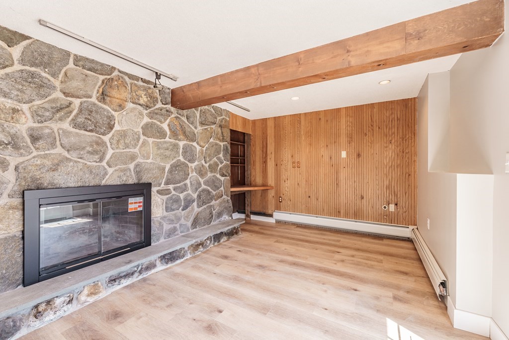 78 Pine Ridge Road Montgomery, MA 01085 - Photo 31 of 42 a view of an empty room with wooden floor and a fireplace