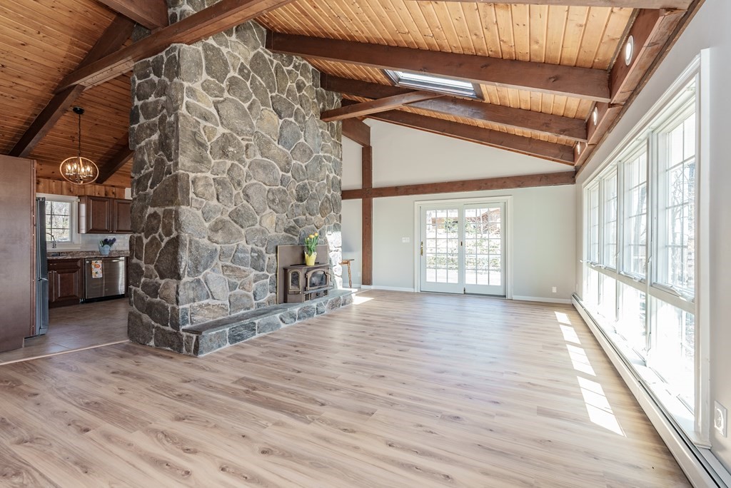 78 Pine Ridge Road Montgomery, MA 01085 - Photo 4 of 42 a view of an empty room with a fireplace and wooden floor