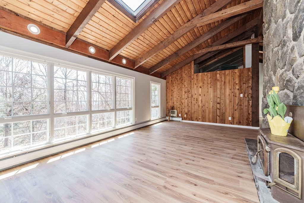78 Pine Ridge Road Montgomery, MA 01085 - Photo 6 of 42 a view of an empty room with wooden floor and a window