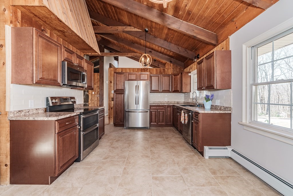 78 Pine Ridge Road Montgomery, MA 01085 - Photo 10 of 42 a kitchen with stainless steel appliances granite countertop a stove a sink dishwasher and a refrigerator
