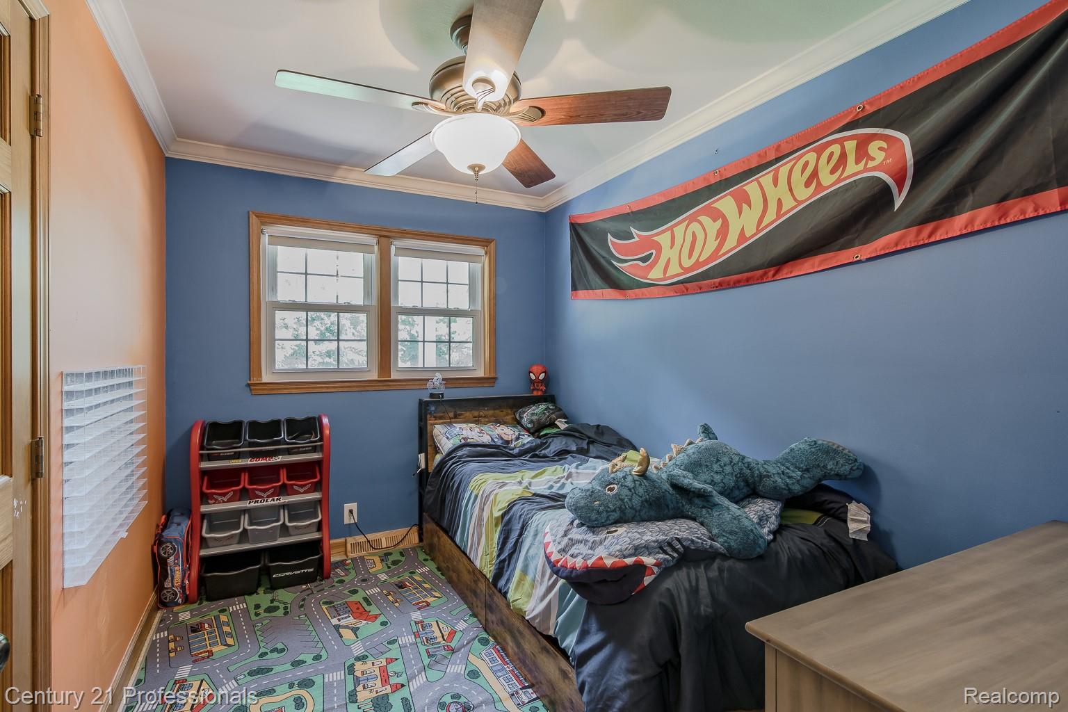 1790 Kent Road Ortonville, MI 48462 - Photo 12 of 64 Bedroom featuring a ceiling fan with light fixture, hardwood window trim, crown molding, and two-tone wall paint