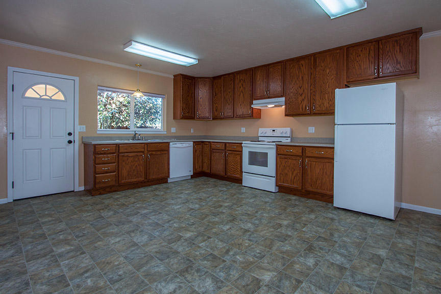 1732 Ash Street Fortuna, CA 95540 - Photo 6 of 37 a kitchen with stainless steel appliances granite countertop wooden cabinets a stove a sink and a refrigerator