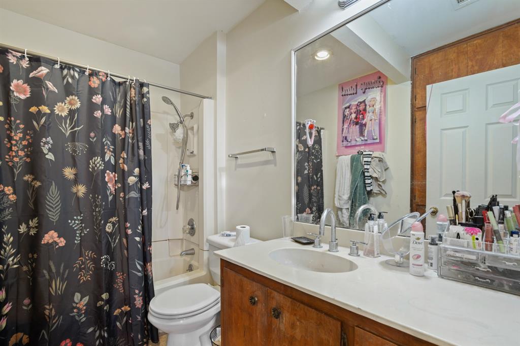 2529 Rio Grande Street, Unit 7 Austin, TX 78705 - Photo 11 of 13 a bathroom with a sink toilet vanity and shower