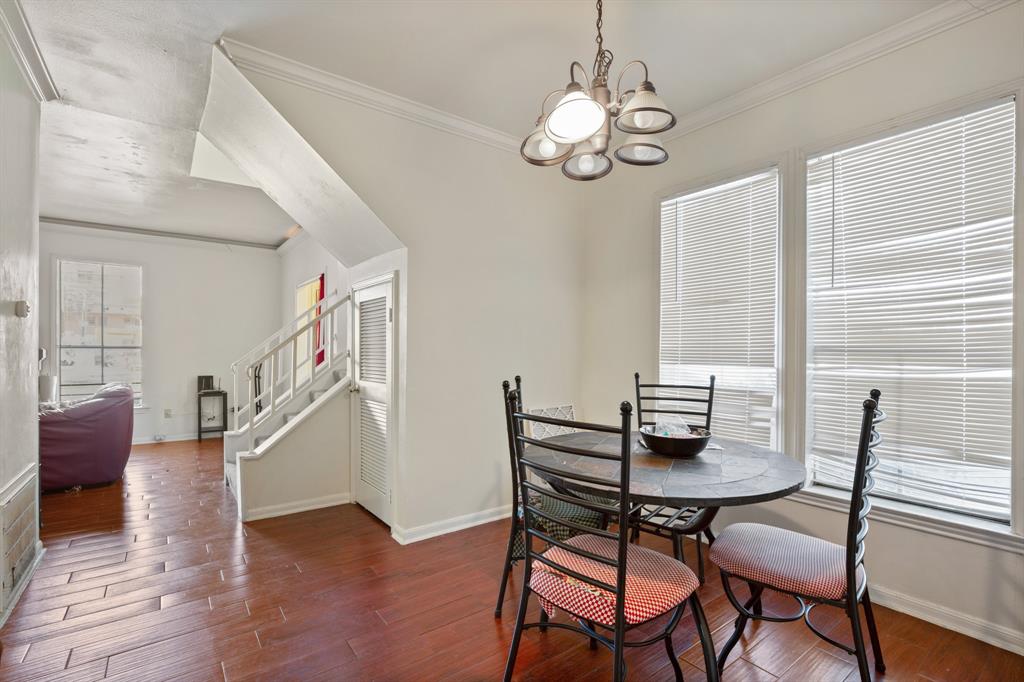 2529 Rio Grande Street, Unit 7 Austin, TX 78705 - Photo 7 of 13 a dining room with wooden floor a chandelier a glass table and chairs