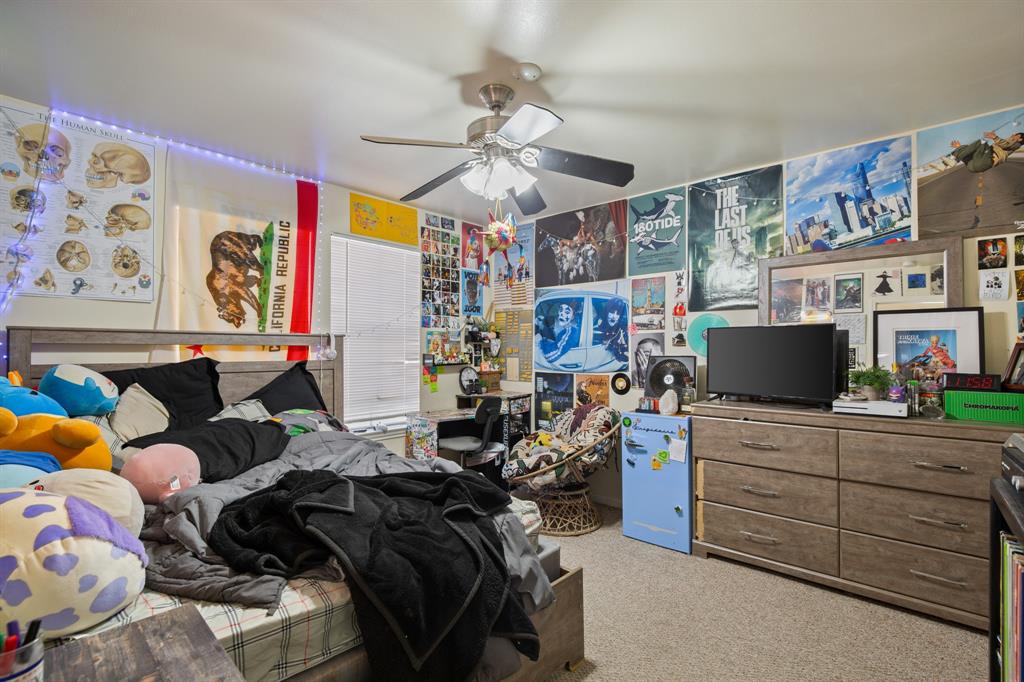 2529 Rio Grande Street, Unit 7 Austin, TX 78705 - Photo 10 of 13 a bedroom with a bed and a chandelier