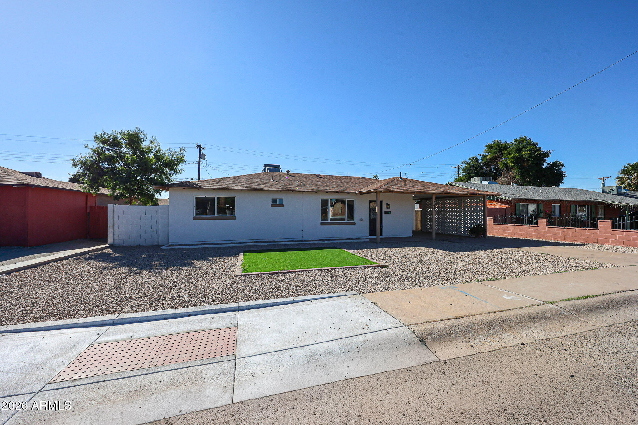 3337 West Ocotillo Road Phoenix, AZ 85017 - Photo 24 of 30 a front view of a house with a yard and a garage
