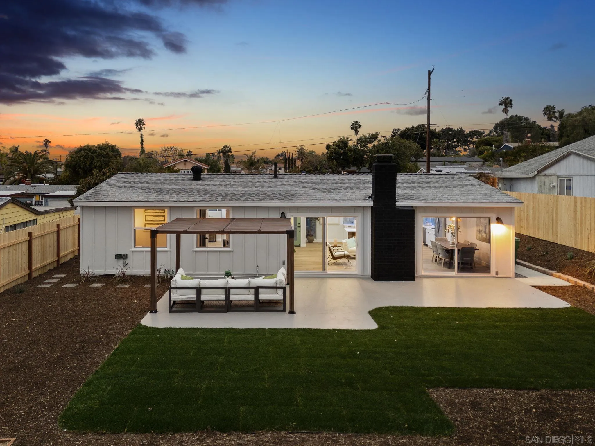 2121 Cardinal Drive San Diego, CA 92108 - Photo 23 of 27 a view of a patio with table and chairs potted plants and a large tree