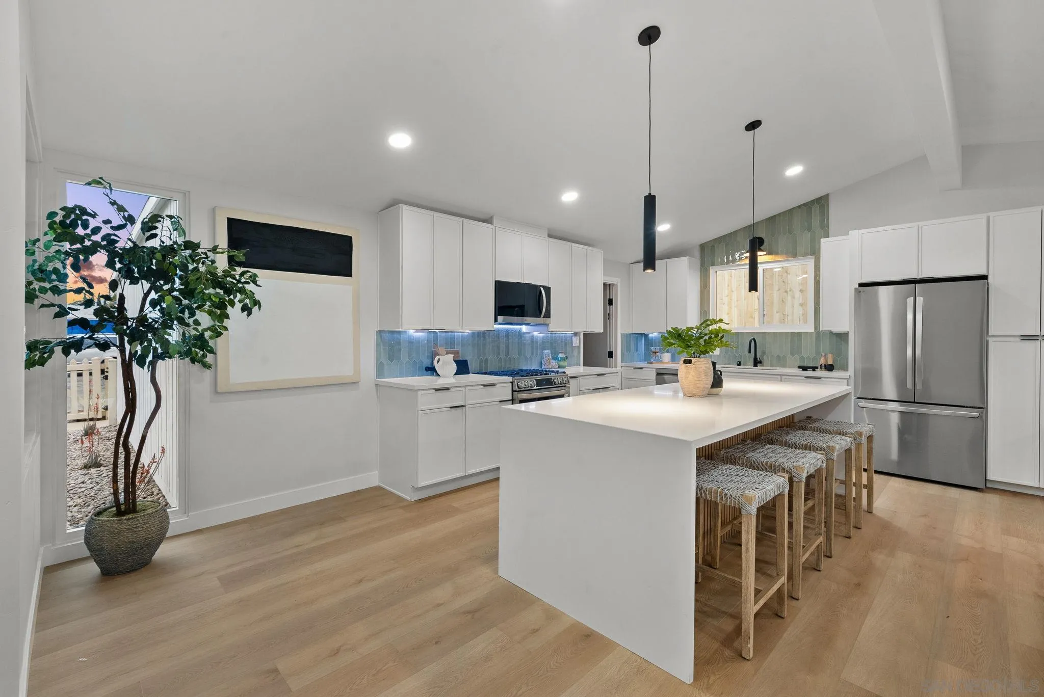 2121 Cardinal Drive San Diego, CA 92108 - Photo 3 of 27 a kitchen with kitchen island a sink appliances and cabinets