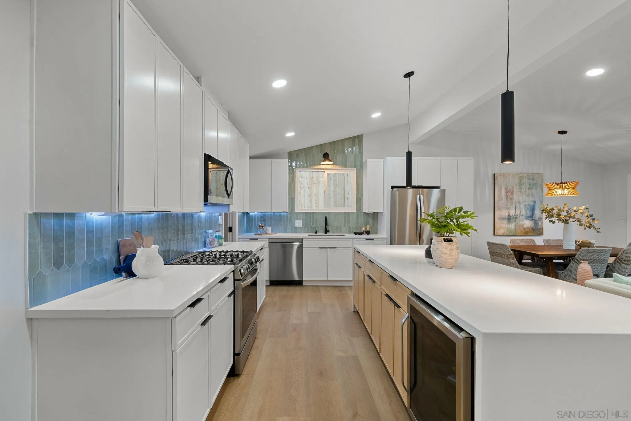 2121 Cardinal Drive San Diego, CA 92108 - Photo 4 of 27 a kitchen with white cabinets sink and stove
