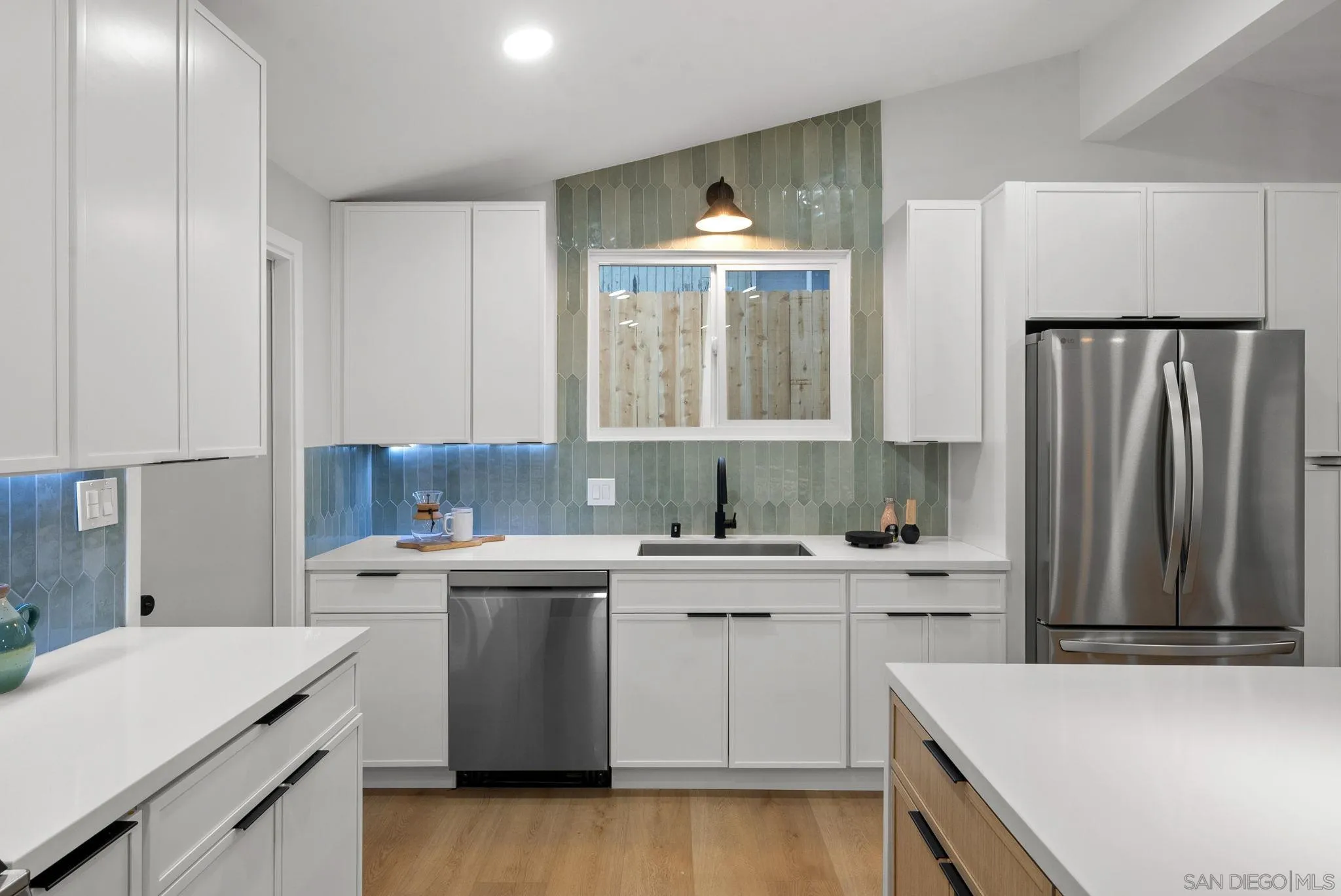 2121 Cardinal Drive San Diego, CA 92108 - Photo 6 of 27 a kitchen with a sink a stove and cabinets