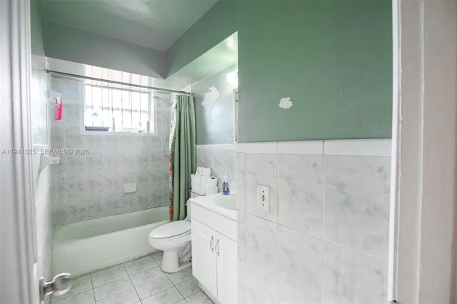 a bathroom with a sink toilet and mirror