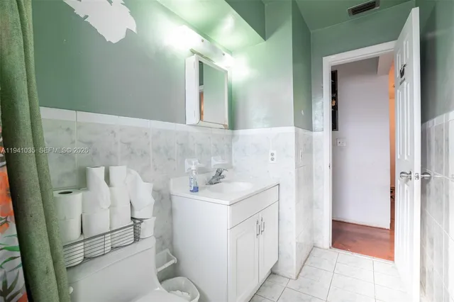 a bedroom with bed and a chandelier