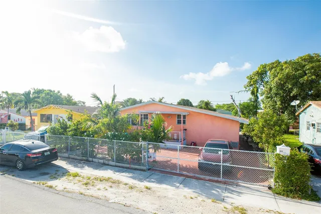 a backyard of a house with a yard and outdoor seating