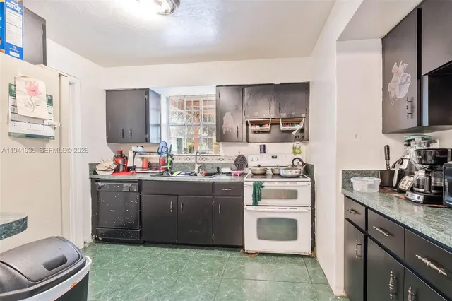 a kitchen with stainless steel appliances a sink stove and refrigerator