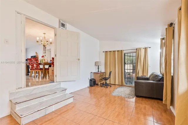 a living room with furniture and large windows