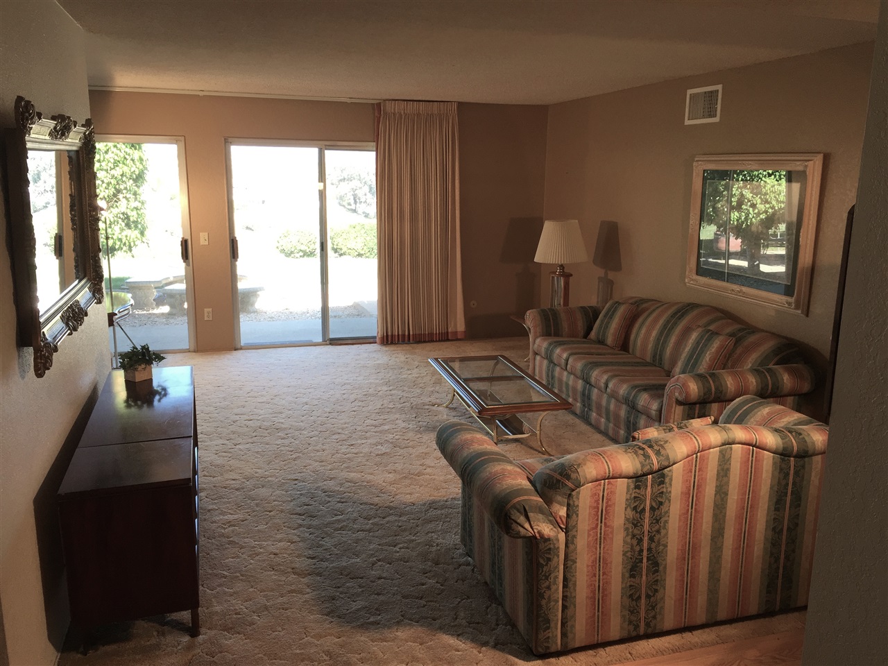 10810 Avenida Roberta Spring Valley, CA 91978 - Photo 5 of 25 TAKE A STEP INSIDE AND YOU CAN SEE FOR MILES - RIGHT THROUGH THE LIVING ROOM WINDOWS.