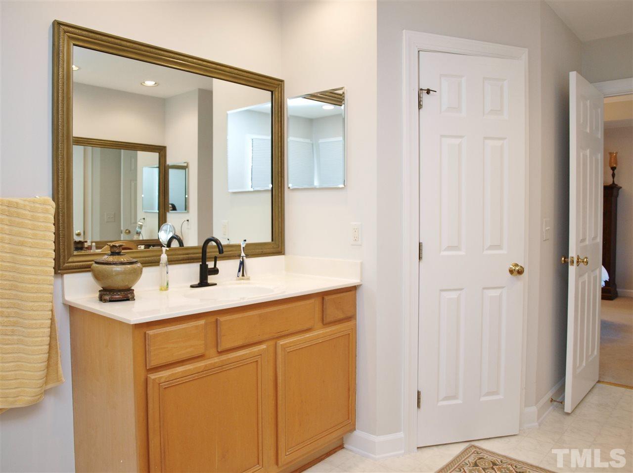 12009 Shavenrock Place Raleigh, NC 27613 - Photo 19 of 30 a bathroom with a sink and a mirror