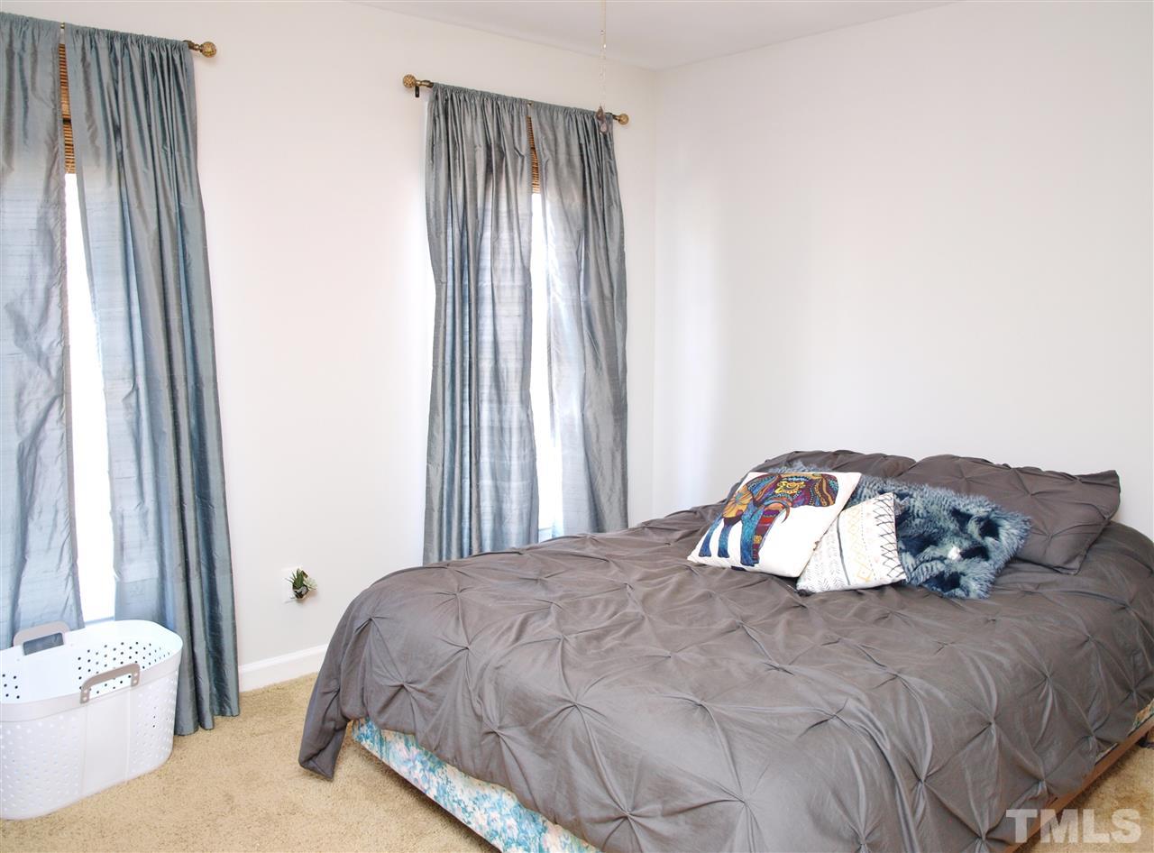 12009 Shavenrock Place Raleigh, NC 27613 - Photo 20 of 30 a bedroom with a bed and a window