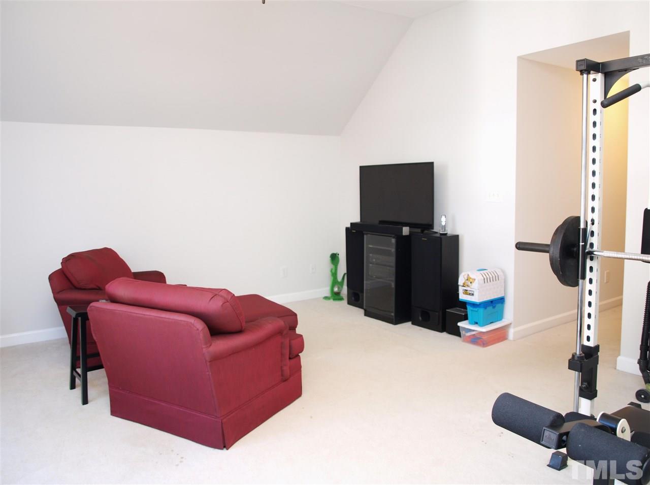 12009 Shavenrock Place Raleigh, NC 27613 - Photo 22 of 30 a living room with furniture and a flat screen tv