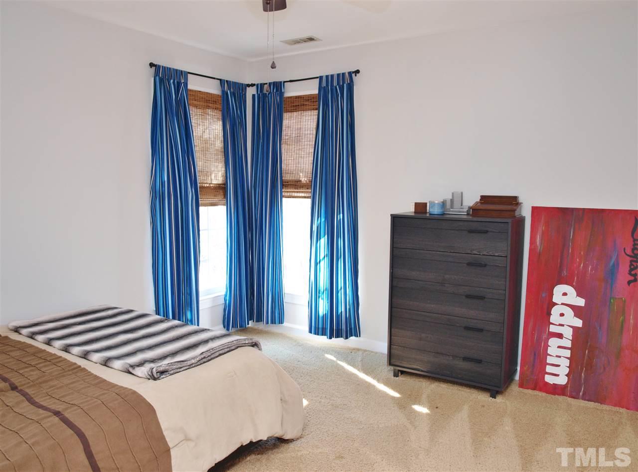 12009 Shavenrock Place Raleigh, NC 27613 - Photo 23 of 30 a bedroom with a bed and a dresser