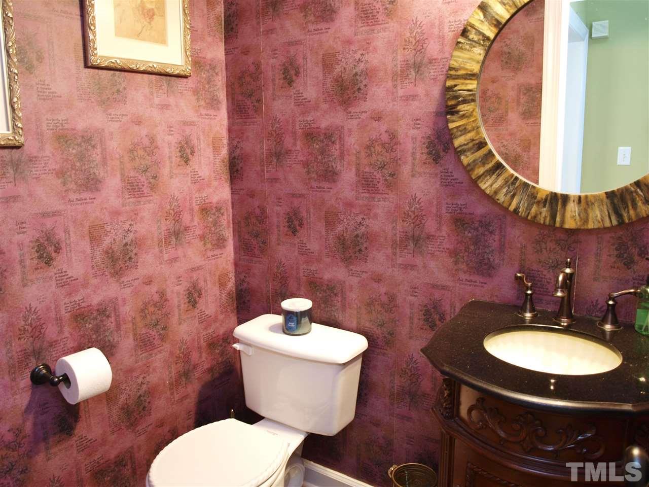12009 Shavenrock Place Raleigh, NC 27613 - Photo 27 of 30 a bathroom with a toilet a sink and mirror