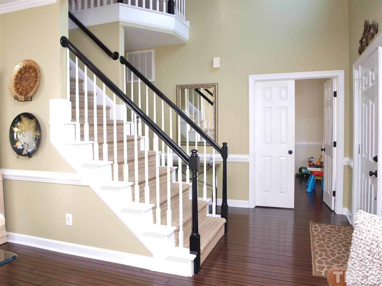 12009 Shavenrock Place Raleigh, NC 27613 - Photo 4 of 30 a view of an entryway with wooden floor and stairs